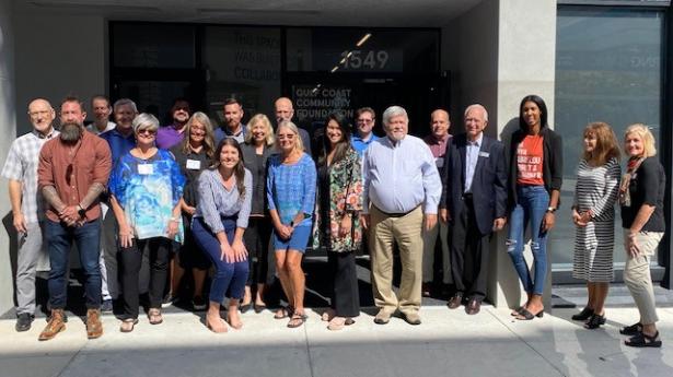 About twenty people standing and smiling outside of Sarasota Philanthropy Center.