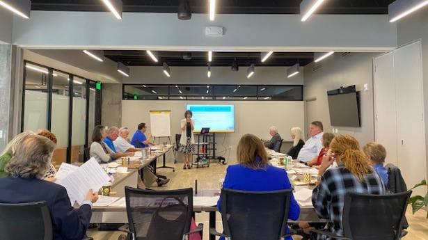Participants from Gulf Coast Community Foundation's Fall Gulf Coast Board Institute sit at tables and listen to speaker.